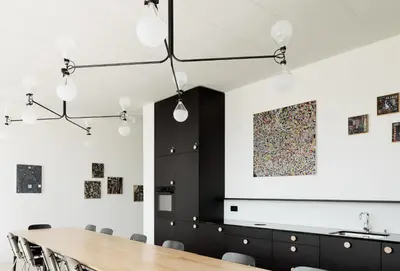 a dining room with a table and a painting on the wall at Gästehaus Meiersegg - HotelFlawil in Flawil