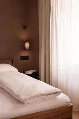 a bedroom with a white bed with a window at normalkonsum - premium apartments in St. Gallen