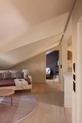 a bedroom with a bed and a living room at normalkonsum - premium apartments in St. Gallen