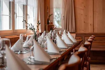 a long table with white napkins and glasses on it at Gasthaus Oberer Gäbris in Gais