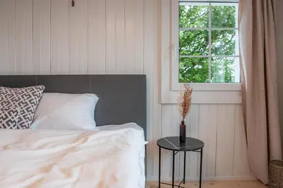 a bedroom with a bed and a table with a window at Gasthaus Oberer Gäbris in Gais