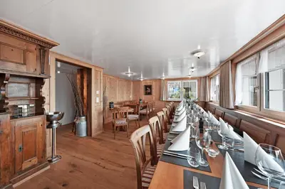 a dining room with a long table with chairs at Gasthaus Oberer Gäbris in Gais
