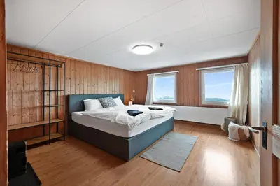 a bedroom with a large bed and two windows at Gasthaus Oberer Gäbris in Gais