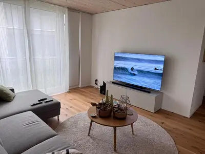 an empty living room with white cabinets and wood floors at Lake & Parkside - Ihr unvergesslicher Bodensee-Aufenthalt in Salmsach
