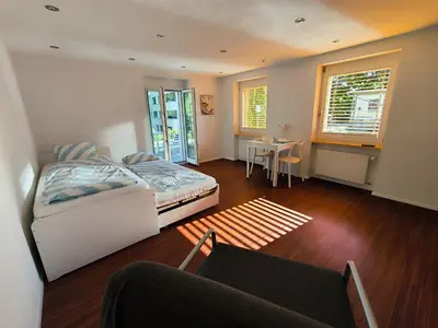 a bedroom with a bed and a table and a window at Charmantes Studio in Teufen in Teufen