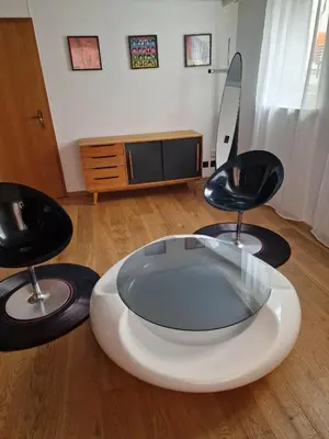 a living room with two chairs and a tv at Kugelgasse Apartments - Smart Living by Klang und Kleid in St. Gallen