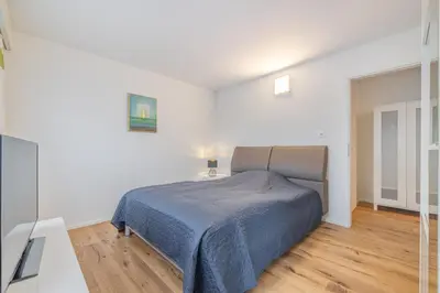 a bedroom with a bed in a white room at Zimmer mit Gemeinschaftsbad in Arbon