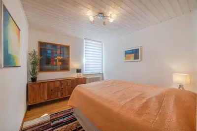 a bedroom with a bed and a window at Zimmer mit Gemeinschaftsbad in Arbon