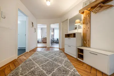 a kitchen with white cabinets and a rug at Zimmer mit Gemeinschaftsbad in Arbon