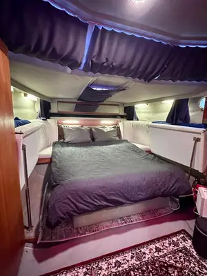 a bed in the middle of a room at Gemütliches Motorboot im Yachthafen von Romanshorn in Romanshorn