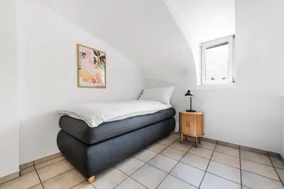 a bedroom with a bed and a table and a window at CITY HOUSE !Gratis Parken, Free Parking! in Kreuzlingen