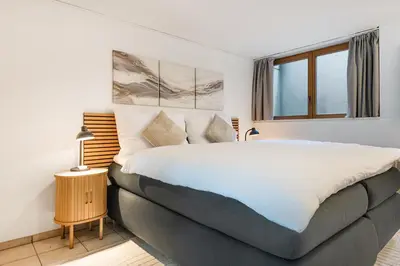 a bedroom with a large bed and a window at CITY HOUSE !Gratis Parken, Free Parking! in Kreuzlingen