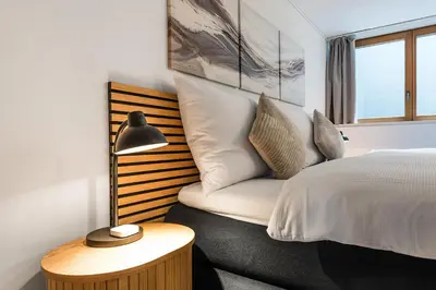 a bedroom with a bed and a couch next to a window at CITY HOUSE !Gratis Parken, Free Parking! in Kreuzlingen