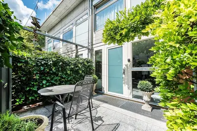 a patio with a table and chairs in front of a building at CITY HOUSE !Gratis Parken, Free Parking! in Kreuzlingen