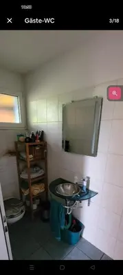 a small bathroom with a sink and a mirror at Zimmer oberhalb einer Schokoladenfabrik in Kreuzlingen