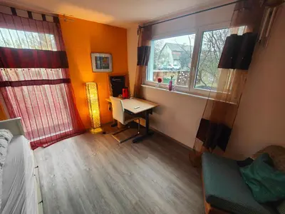 a room with a desk and a window and a bed at Zimmer oberhalb einer Schokoladenfabrik in Kreuzlingen