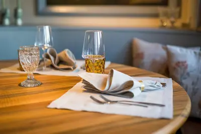 a table with a napkin and a glass of wine at Gasthaus zur Sonne - Hotel - Restaurant - Boutique in Gossau
