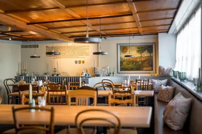 a restaurant with tables and chairs and a bar at Gasthaus zur Sonne - Hotel - Restaurant - Boutique in Gossau