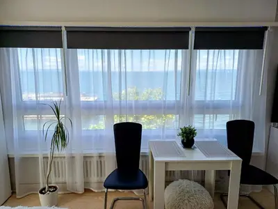 a flat screen tv on a white entertainment center at Studio Marylin in Rorschach