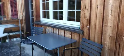 a table and two chairs in front of a window at Modern trifft Tradition in Grabs