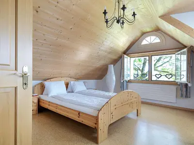 a bedroom with a bed with a wooden ceiling at Hotel B&BAlpenheim in Teufen