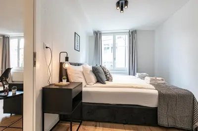 a small bedroom with a bed and a window at book2stay - Apartments Spisertor in St. Gallen