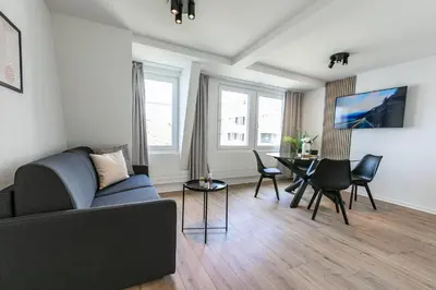 a living room with a couch and a table at book2stay - Apartments Spisertor in St. Gallen