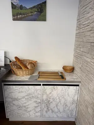 a cabinet with baskets on top of it next to a wall at Bergnest Wildhaus in Wildhaus