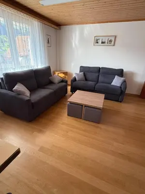 a living room with two couches and a coffee table at Bergnest Wildhaus in Wildhaus