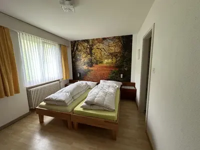a room with a bed with a painting on the wall at Bergnest Wildhaus in Wildhaus