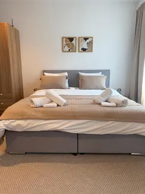 a bedroom with a large bed with towels on it at Studio mit Balkon im Zentrum in St. Gallen