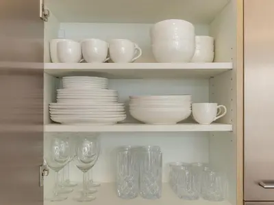 a cupboard filled with plates and dishes and glasses at WYBA Living - Modernes Apartment - Gratis ÖV - Ruhig & Zentral in St. Gallen