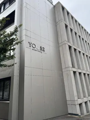 a building with a sign on the side of it at WYBA Living - Modernes Apartment - Gratis ÖV - Ruhig & Zentral in St. Gallen