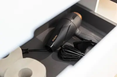 a hairdryer sitting on top of a counter at BLIV Design-Apartment mit Parkplatz, nahe Zentrum in St. Gallen