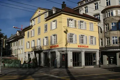 a yellow building on the corner of a street at Kränzlin Hotel in St. Gallen