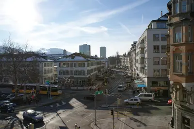 a bedroom with a large white bed and a window at Kränzlin Hotel in St. Gallen