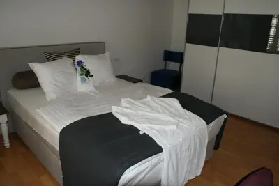 a small bedroom with a bed and a table at Kränzlin Hotel in St. Gallen
