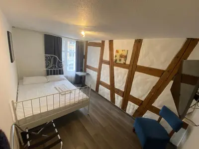 a bed with pillows on it in a room at Kränzlin Hotel in St. Gallen