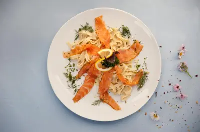 a plate of food with shrimp and pasta at Hotel und Restaurant Wolfensberg in Degersheim