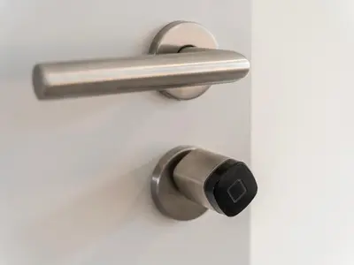 a metal door handle on a white door at Stilvoll&zentral in St Gallen -WYBA Living P in St. Gallen