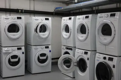 a group of washing machines and washers in a laundry room at Stilvoll&zentral in St Gallen -WYBA Living P in St. Gallen