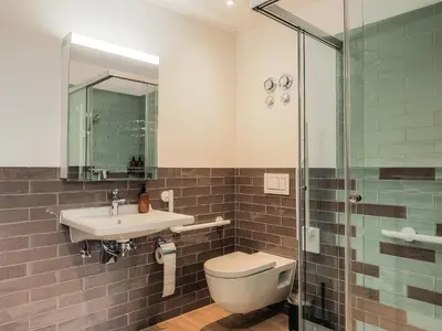 a bathroom with a toilet and a sink and a shower at Stilvoll&zentral in St Gallen -WYBA Living P in St. Gallen