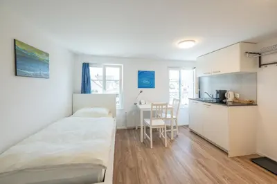 a small room with a bed and a desk at CasaMia Flawil in Flawil