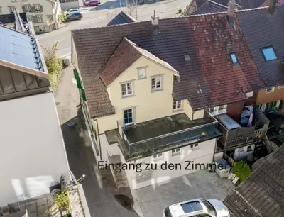an overhead view of a white house with a roof at CasaMia Flawil in Flawil