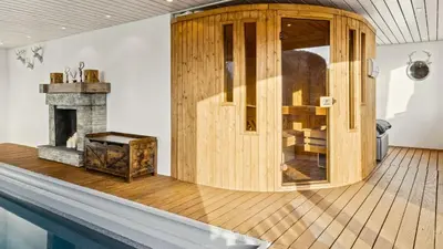 a staircase in a house with a mountain decal on the wall at Suite4you Erlen l Privater Pool ganzjährig beheizt & Sauna l 10min zum Bodensee, Parkplatz & WLAN in Erlen