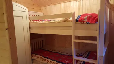a bunk bed in a log cabin with a bunk bed in a room at SwissCottages Blockhaus in Schönengrund