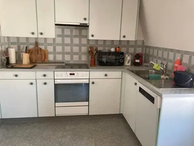 a kitchen with white cabinets and a sink at Euer Domizil im Herzen von Altstätten SG, Schweiz in Altstätten