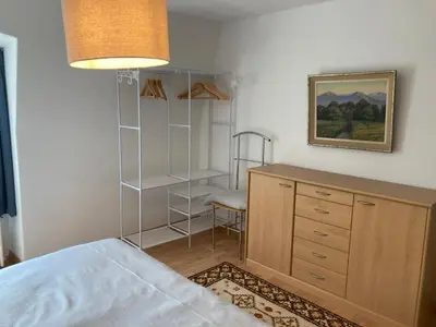 a bedroom with a bed and a dresser and a desk at Euer Domizil im Herzen von Altstätten SG, Schweiz in Altstätten