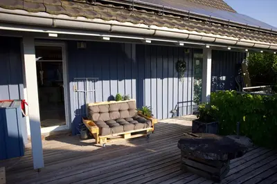 a garden with a bench and a table and a tree at Apartment with charm and dream view in Hosenruck