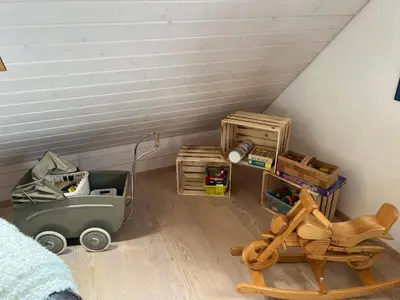a bedroom with a bed with a comforter and a window at Apartment with charm and dream view in Hosenruck